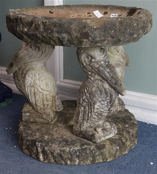 A reconstituted stone bird bath with pelican supports W.57cm